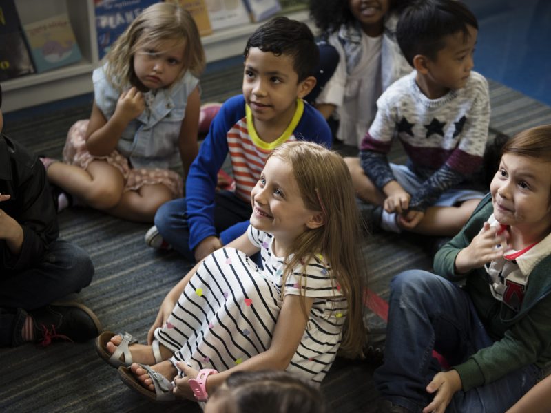 Kindergarten students sitting on the floor
